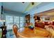 Bright dining area with wood table and chairs, view to living room and screened patio at 390 Cypress Creek Cir, Oldsmar, FL 34677