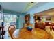 Bright dining area with wood table and chairs, view to living room and screened patio at 390 Cypress Creek Cir, Oldsmar, FL 34677