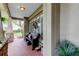 Relaxing front porch with brick floor and wooden bench at 390 Cypress Creek Cir, Oldsmar, FL 34677