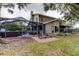 Screened patio with hot tub and seating area at 390 Cypress Creek Cir, Oldsmar, FL 34677