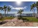 Waterfront backyard with patio and tropical landscaping at 620 Boca Ciega Isle Dr, St Pete Beach, FL 33706