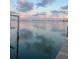 Stunning waterfront view at sunset, showcasing calm water and distant cityscape at 620 Boca Ciega Isle Dr, St Pete Beach, FL 33706