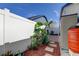 Landscaped backyard with a walkway and storage shed at 8622 Thimbleberry Ln, Tampa, FL 33635