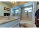 Bathroom with bathtub, single vanity, and large mirror at 8622 Thimbleberry Ln, Tampa, FL 33635