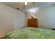 Bedroom with queen-size bed, wood dresser, and closet at 8622 Thimbleberry Ln, Tampa, FL 33635