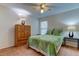 Bedroom with queen-size bed, wood dresser, and ceiling fan at 8622 Thimbleberry Ln, Tampa, FL 33635