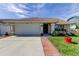 One story home with attached garage and manicured lawn at 8622 Thimbleberry Ln, Tampa, FL 33635