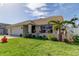 One-story home with attached garage, landscaped yard, and palm trees at 8622 Thimbleberry Ln, Tampa, FL 33635