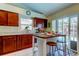 Bright kitchen with breakfast bar, granite counters & pool view at 8622 Thimbleberry Ln, Tampa, FL 33635