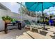 Relaxing pool area with lounge chairs and a blue umbrella at 8622 Thimbleberry Ln, Tampa, FL 33635