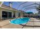 Relax by the refreshing pool in this screened enclosure at 8622 Thimbleberry Ln, Tampa, FL 33635