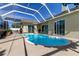 Refreshing kidney-shaped pool with screened enclosure at 8622 Thimbleberry Ln, Tampa, FL 33635