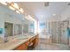 Bright bathroom featuring double sinks, a glass shower, and a soaking tub at 1120 Emerald Dunes Dr, Sun City Center, FL 33573