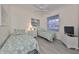 Well-lit bedroom with two twin beds, modern decor, and a serene atmosphere at 1120 Emerald Dunes Dr, Sun City Center, FL 33573