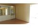 Bedroom with mirrored closet and access to a balcony at 2462 Brazilia Dr # 20, Clearwater, FL 33763