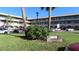 Building exterior, featuring landscaped grounds and parking at 2462 Brazilia Dr # 20, Clearwater, FL 33763