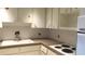 Cozy kitchen featuring white cabinets and appliances at 2462 Brazilia Dr # 20, Clearwater, FL 33763
