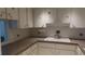 Kitchen with white cabinets, a corner sink, and stove at 2462 Brazilia Dr # 20, Clearwater, FL 33763