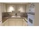 Small kitchen with white cabinets and built-in oven at 2462 Brazilia Dr # 20, Clearwater, FL 33763
