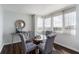 Bright dining room with glass table and four gray chairs at 660 Island Way # 908, Clearwater Beach, FL 33767
