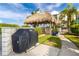 Enjoy outdoor cooking in this covered grilling area, complete with a built-in grill and thatched roof at 660 Island Way # 908, Clearwater Beach, FL 33767