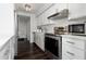 Updated kitchen with stainless steel appliances and white cabinets at 660 Island Way # 908, Clearwater Beach, FL 33767