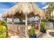 Relax in this shaded seating area with a thatched roof and waterfront views at 660 Island Way # 908, Clearwater Beach, FL 33767