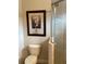 Bathroom includes toilet, shower, and modern artwork at 297 Martellago Dr, North Venice, FL 34275