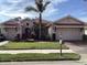 Beautiful two-story home with a red tile roof and lush landscaping at 297 Martellago Dr, North Venice, FL 34275