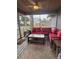 Relaxing screened porch with red couch and coffee table at 1003 W Mahoney St, Plant City, FL 33563