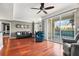 Living room with hardwood floors, a ceiling fan, and sliding doors leading to a balcony at 345 Bayshore Blvd # 308, Tampa, FL 33606