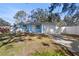 Newly built light blue home with a white garage door and fenced yard at 615 W Virginia Ave, Tampa, FL 33603