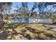 Newly built light blue home with a white garage door and fenced yard at 615 W Virginia Ave, Tampa, FL 33603