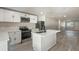 Modern white kitchen with stainless steel appliances and island at 615 W Virginia Ave, Tampa, FL 33603