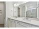 Bathroom with double vanity, quartz countertop and a frameless shower at 9442 Shorebird Ct, Parrish, FL 34219