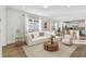 Bright living room with a white sofa, wood floors, large windows, and an open floor plan at 9442 Shorebird Ct, Parrish, FL 34219