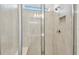 Modern shower with glass enclosure, built-in seat, and tile surround at 9442 Shorebird Ct, Parrish, FL 34219