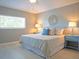 Inviting bedroom features soft lighting from bedside lamps and a large window, creating a relaxing atmosphere at 15618 Shoal Creek Pl, Odessa, FL 33556