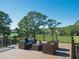 Inviting outdoor deck area with comfortable seating and picturesque views of the surrounding landscape at 15618 Shoal Creek Pl, Odessa, FL 33556