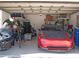 Organized garage featuring a car, storage shelves, and ample space for vehicles and equipment at 15618 Shoal Creek Pl, Odessa, FL 33556