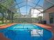 Secluded backyard pool with a screened enclosure, offering a private oasis for relaxation and recreation at 15618 Shoal Creek Pl, Odessa, FL 33556