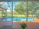 Relaxing pool area with screened enclosure and view of the backyard at 15618 Shoal Creek Pl, Odessa, FL 33556