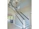 Elegant staircase with modern design, contrasting railings, and ample natural light at 15618 Shoal Creek Pl, Odessa, FL 33556