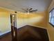 Bright bedroom with hardwood floors and ceiling fan at 2525 W Bay Dr # A32, Belleair Bluffs, FL 33770