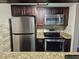 Stainless steel appliances and granite countertops in this kitchen at 2525 W Bay Dr # A32, Belleair Bluffs, FL 33770