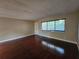 Living room with hardwood floors and large window at 2525 W Bay Dr # A32, Belleair Bluffs, FL 33770