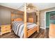 Bright bedroom featuring a wooden canopy bed and wood-look floors at 3607 E Bay Dr # 211, Holmes Beach, FL 34217