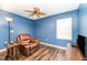 Serene bedroom with leather recliner and wood-look floors at 3607 E Bay Dr # 211, Holmes Beach, FL 34217