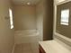 Bathroom with an oval tub and a vanity with a framed mirror at 5337 Treig Ln, Wesley Chapel, FL 33545