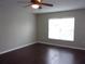 Bedroom with dark hardwood floors and a window with blinds at 5337 Treig Ln, Wesley Chapel, FL 33545